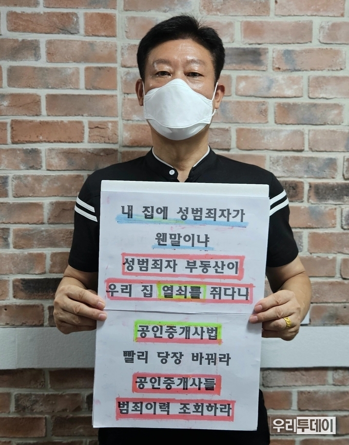 1인시위에 참여한 은평구 응암동에 거주하는 김익규씨가 팻말을 들고 서있다.